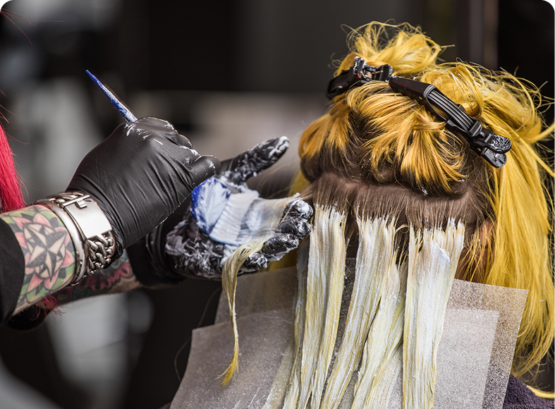 Coloring hair with brush and foil technique.