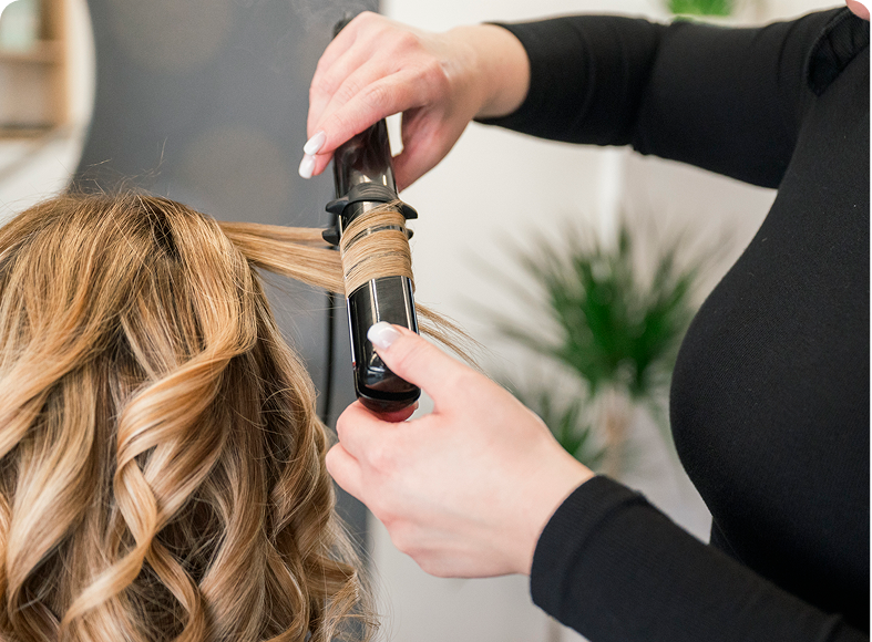 Hair being curled by hairstylist