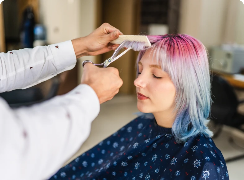 Woman getting a pastel hair trim