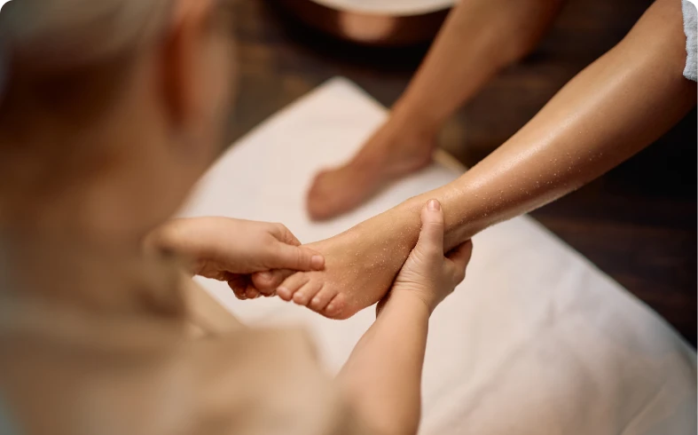 Hands massaging a person's foot