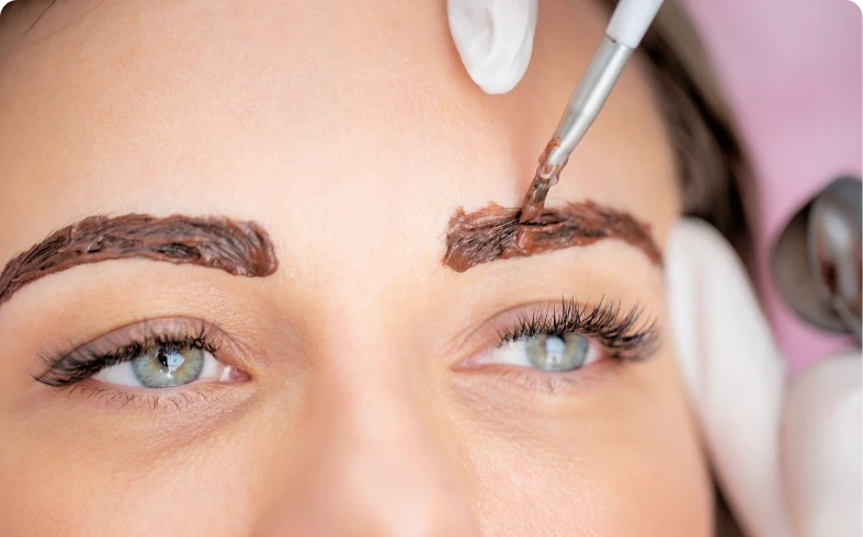 Close-up of eyebrow tint application