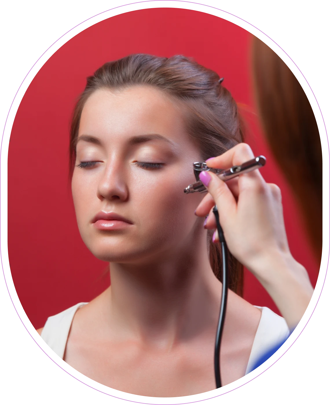 Airbrush makeup application on woman's face